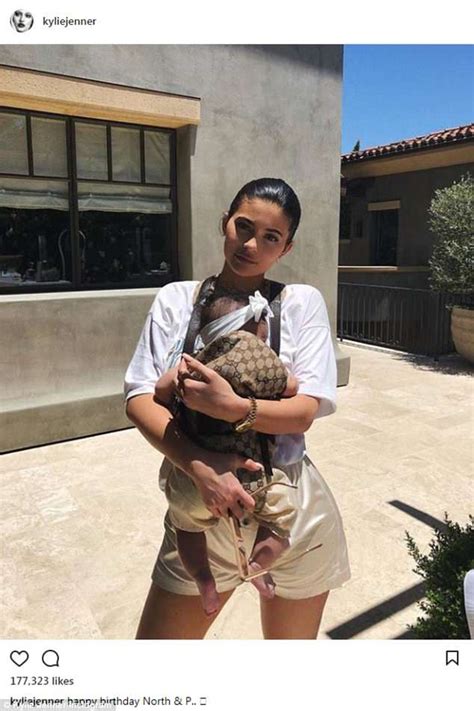 Kylie Jenner Holds Baby Stormi in an 0 Gucci Baby Carrier